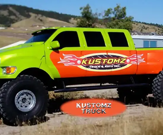 Lime green and orange six-door lifted Ford truck with flame graphics on a hillside